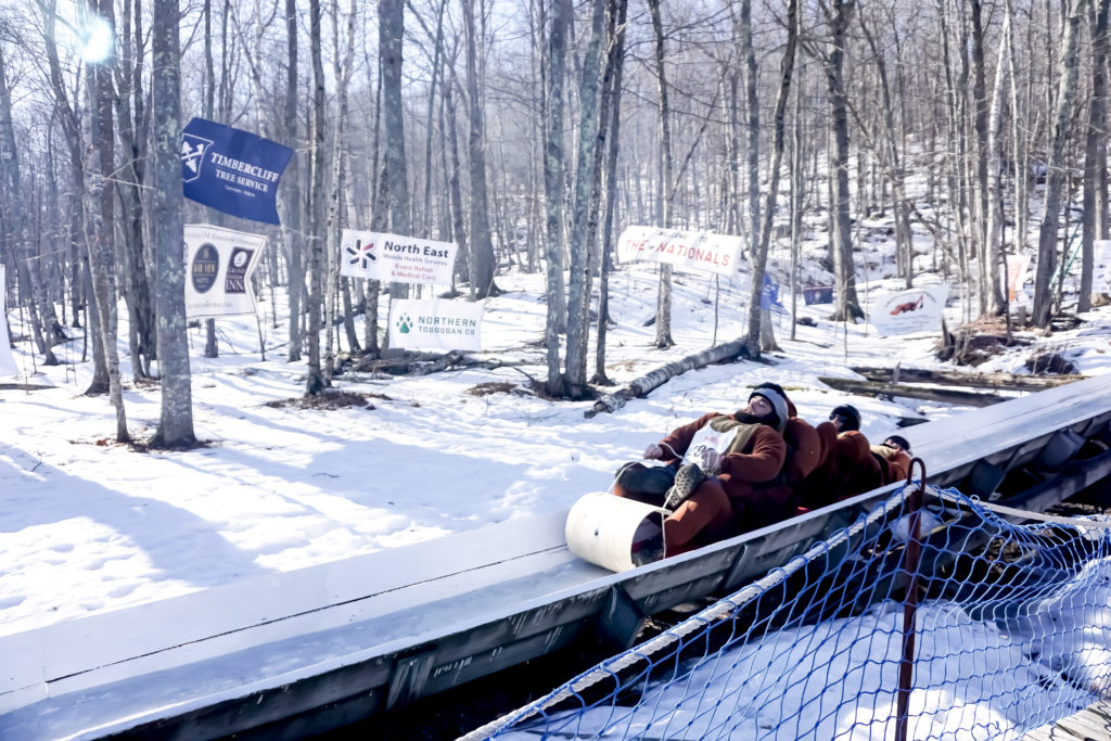 a four person toboggan team going down the slide