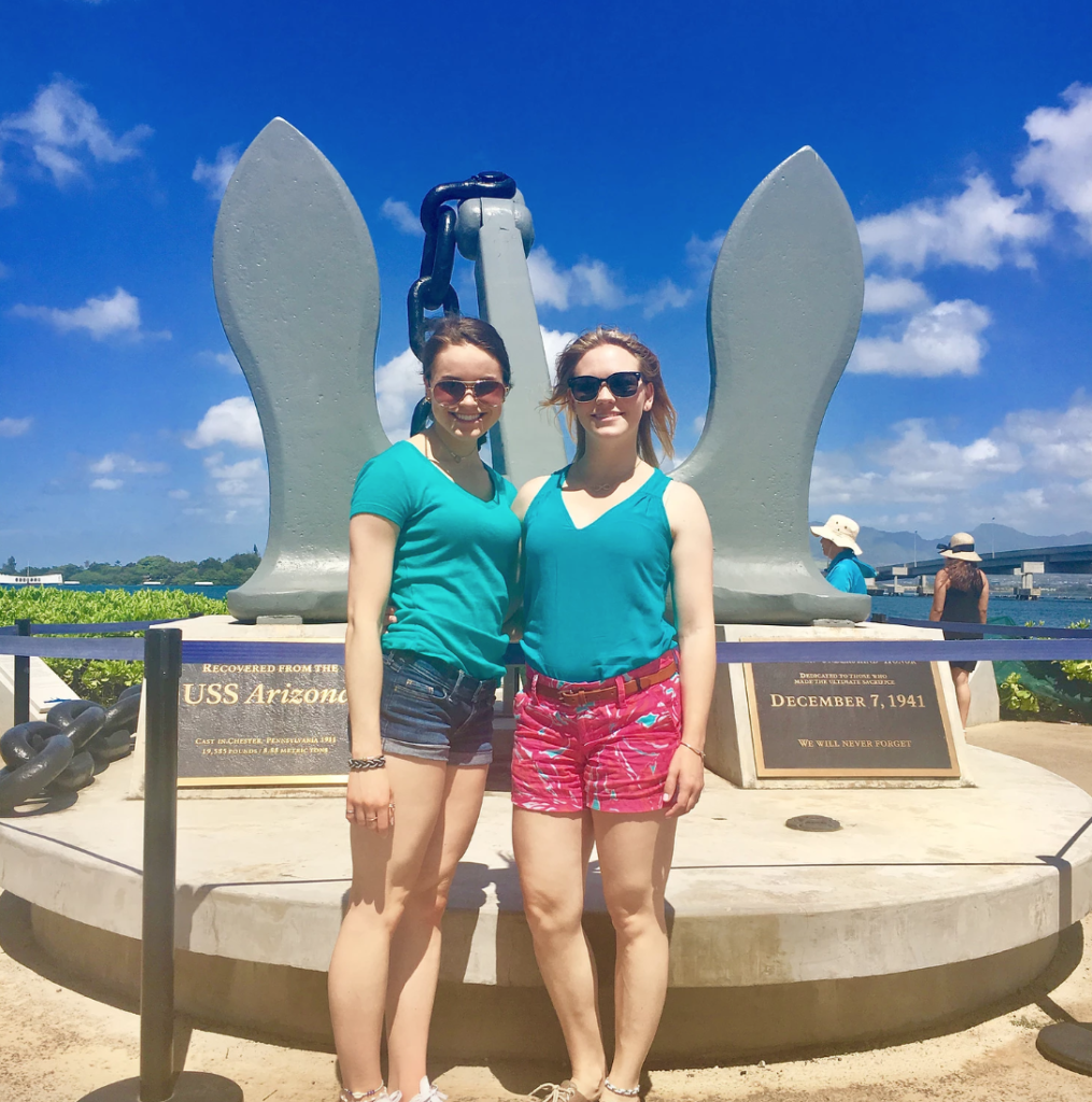 my sister and I in front of the USS Arizona memorial anchor