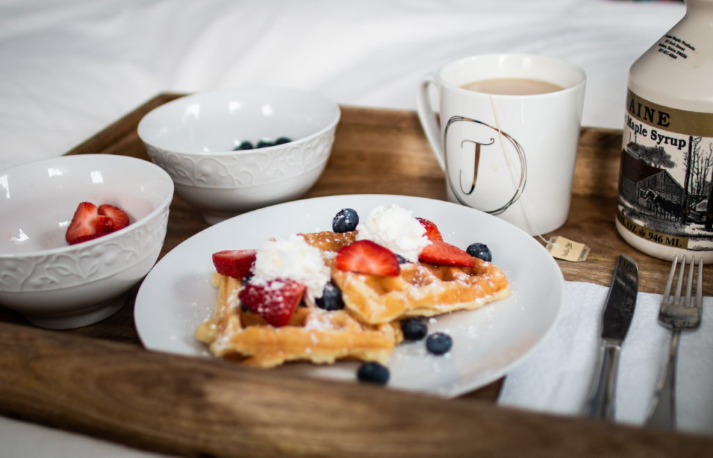 waffles with powdered sugar and whipped cream