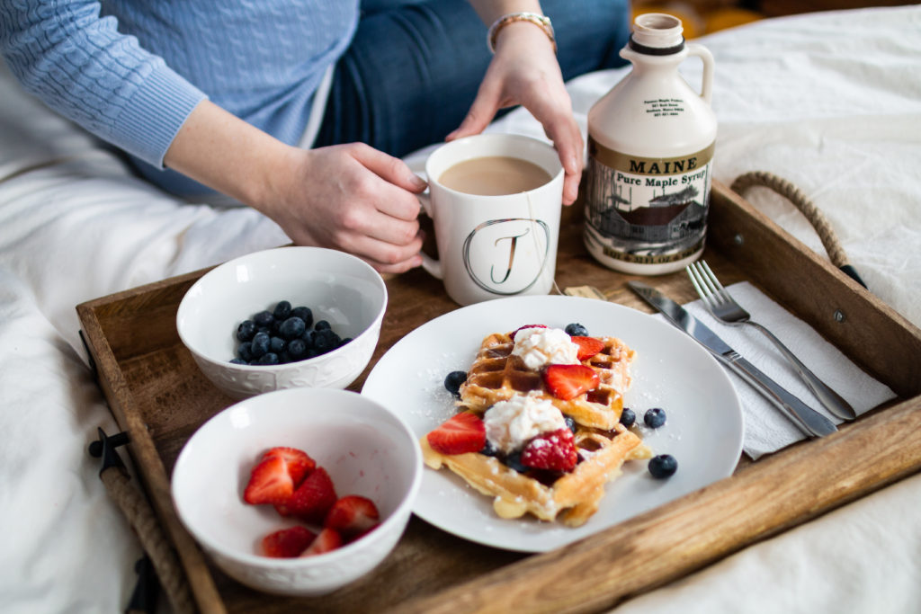 waffles and strawberries and blueberries and tea and maple syrup