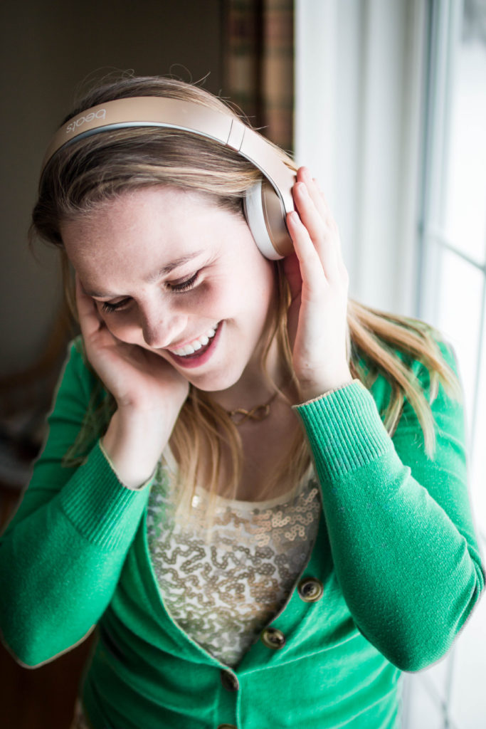 girl wearing headphones and listening to music 