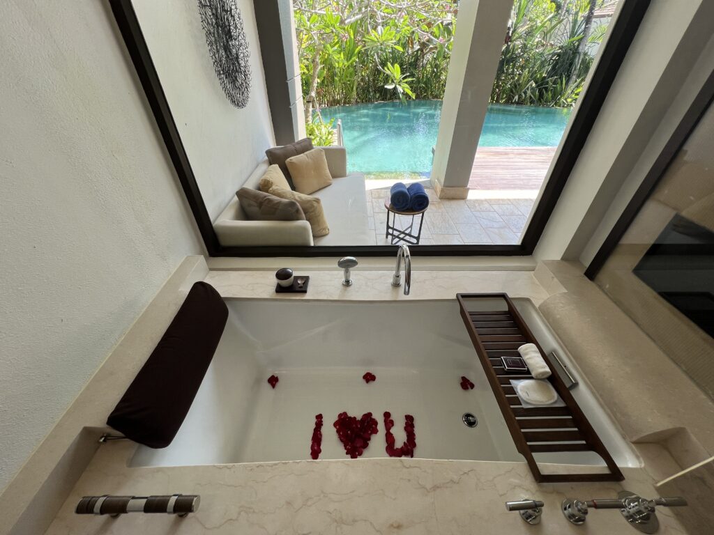 our bathtub that overlooks the lagoon access and our deck filled with rose petals that spell out I heart u