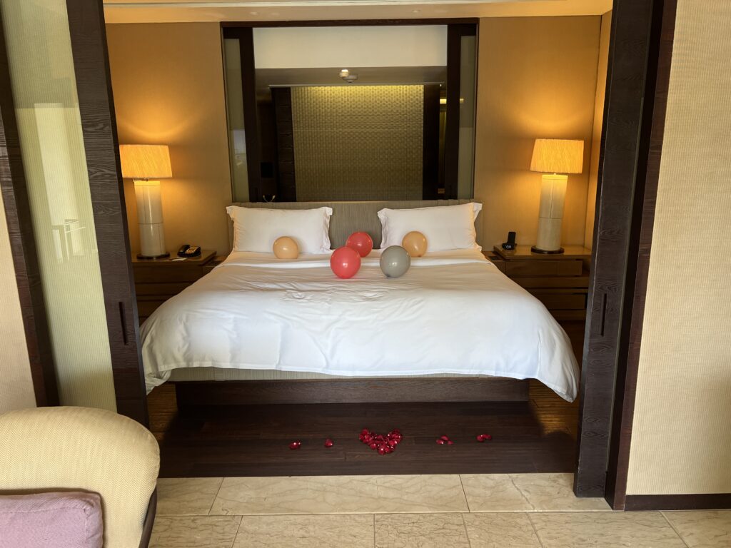 balloons and rose petals on our master bed